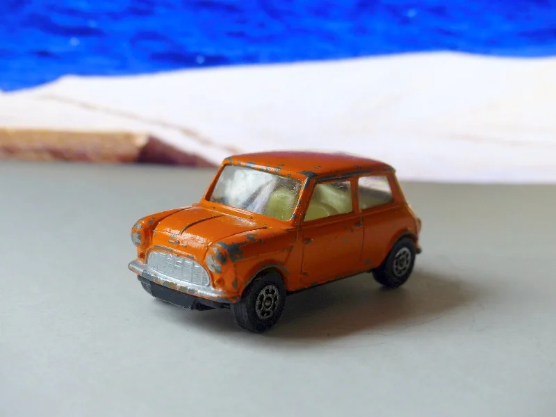 Hybrid cars combining fuel and electric power for efficiency​ 204 Morris Mini-Minor in orange with black base